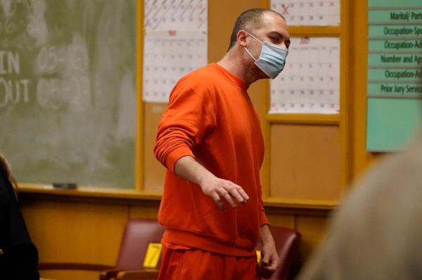 Nima Momeni in orange prison clothes